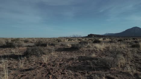 Speeding-over-ground,-dry-territory-with-sparse-vegetation-Utah,-USA