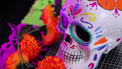 Colorful-Day-of-the-Dead-skull-decoration-with-vibrant-flowers,-close-up