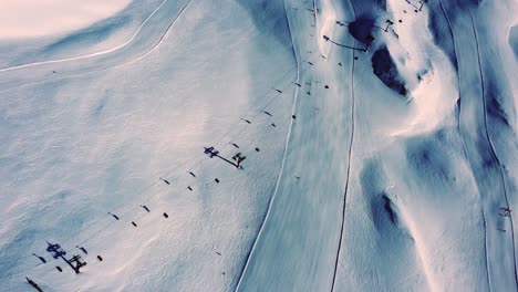 Ski-slopes-with-lift-in-Austrian-alps,-aerial-shot