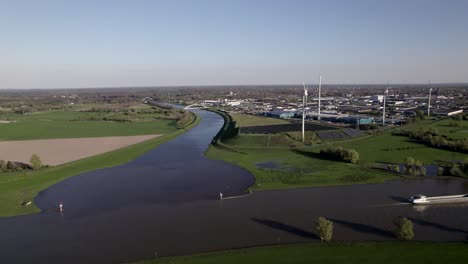 Aerial-reveal-of-wind-turbine-in-The-Netherlands-next-to-Twentekanaal-meeting-river-IJssel