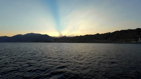 Silhouette-Mountain-Range-From-The-Sea-At-Sunset-In-Dahab,-Egypt
