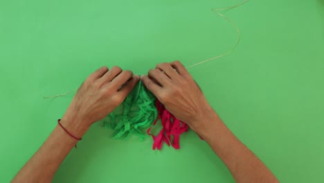 Making-colorful-green-red-and-white-garland-with-paper-crafts