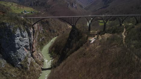 Tara-bridge-in-Montenegro,-over-which-cars-pass-and-the-Tara-river-flows-under-them