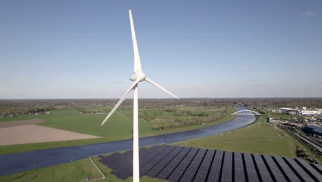 Clean-energy-hub-wind-turbine-facility-and-solar-panels-in-The-Netherlands-with-inland-shipping-Twentekanaal-in-the-background