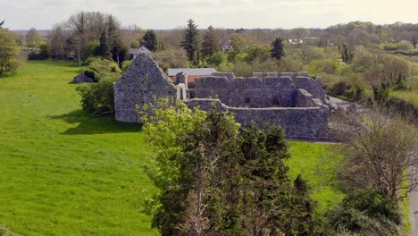 "Annaghdown-Abbey:-Aerial-ascend-reveals-ruins-from-behind-tree