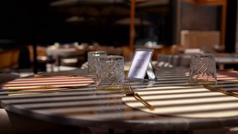 Front-view-of-stylish-and-light-dining-table-in-restaurant-close-up-shot