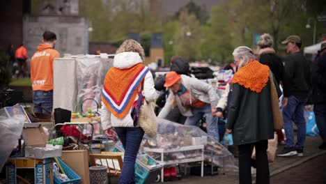 Handheld-King's-day-view-on-garage-sale-flea-market-with-persons-searching