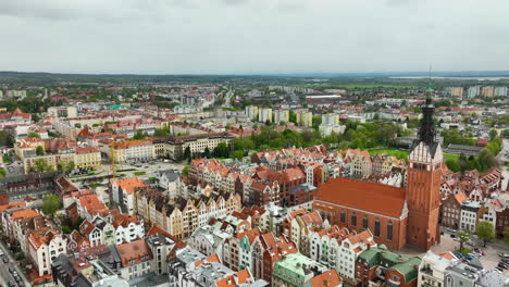 An-expansive-aerial-view-of-Elbląg-shows-the-contrast-between-the-vibrant,-historical-center-with-its-richly-colored-rooftops-and-the-modern-suburban-spread