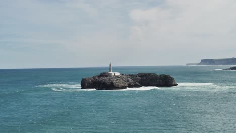 Lighthouse-on-top-of-a-rock-in-the-middle-of-te-ocean