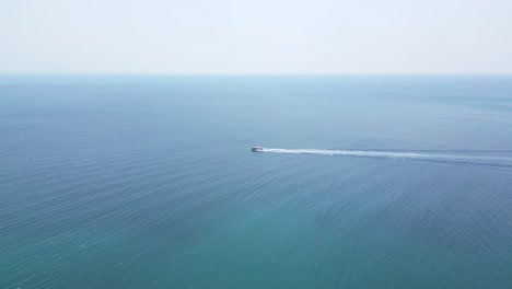 Tracking-speed-boat-on-open-ocean---slow-motion-drone-shot