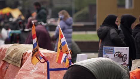 Two-Dutch-flags-close-up-of-Kingsday-garage-sale-flea-market-Koningsdag