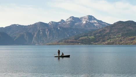 Two-fishermen-on-small-boat,-on-Attersee-Lake-in-Austria