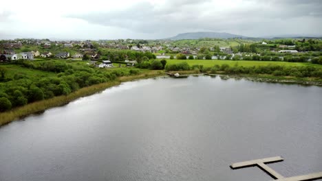 Aerial-reveal-shot-flying-over-Lough-Erne-in-Enniskillen,-Northern-Ireland-on-a-sunny-day