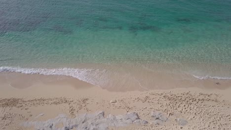 established-aerial-of-tropical-sandy-beach-with-clear-pristine-water-waves