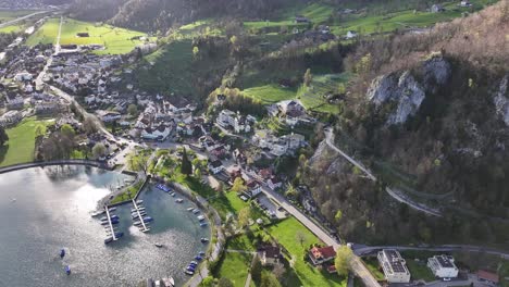 Drone-captures-beautiful-aerial-view-of-Walensee-Wessen,-Switzerland,-contains-lake,-houses,-roads---Village
