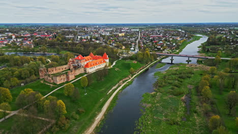 Aerial-view-of-the-Bauska-Castle-Museum-and-the-Musa-river,-spring-in-Latvia
