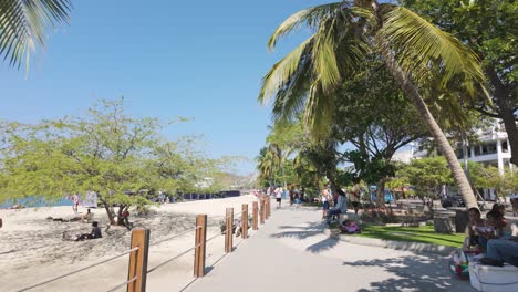 Walking-through-street-vendors-in-the-Santa-marta-promenade,-Beachfront-strolling