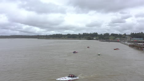 2024-UIM-World-Jet-Boat-River-Racing-Championship-in-Bandon-Oregon,-slow-drone-over-waiting-boats-on-the-Coquille-River