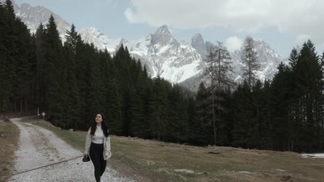 A-Girl-With-A-Camera-Near-Dolomite-Mountain-Ridge-In-Italy