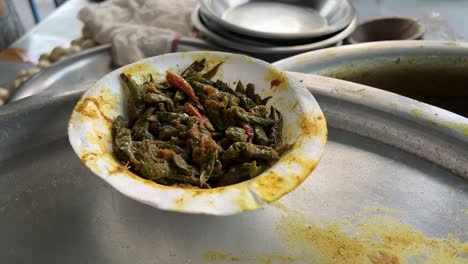 Close-up-shot-of-sautéed-green-beans-in-a-paper-cup-at-a-roadside-food-stall-in-India