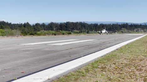 Cal-Ore-Life-Flight-propeller-airplane-taking-off,-closeup-shot-from-side-of-runway