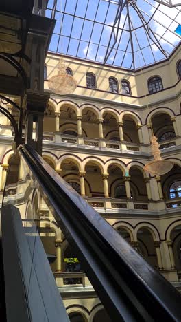 Vertical-Video,-National-Palace-Shopping-Mall-and-Art-Gallery,-Escalator-POV