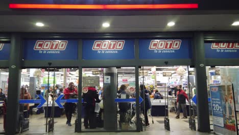Coto-famous-supermarket-of-argentina-people-buy-groceries-entrance-store-establishing-shot-panoramic-at-night-in-buenos-aires-city