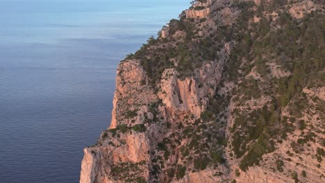 Ibiza-seaside-cliff-basking-in-warm-glow-of-sunset