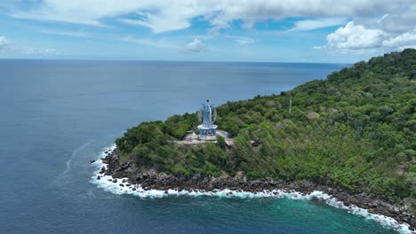 Kilometer-nol-monument-on-weh-island,-indonesia,-surrounded-by-lush-greenery-and-ocean,-aerial-view