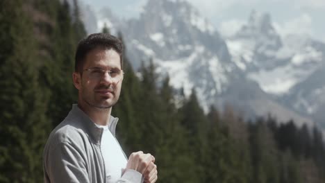 Male-Tourist-In-Eyeglasses-By-The-Dolomite-Mountains-In-Italy-On-Sunny-Day