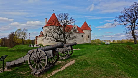 POV-shot-walking-in-front-of-canons-with-the-Bauska-Castle-Museum-in-the-background