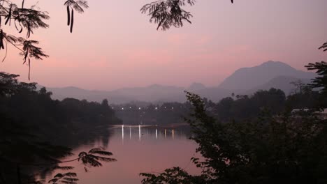 pink-skies-before-sunrise-over-the-river-in-Luang-Prabang,-Laos-traveling-Southeast-Asia
