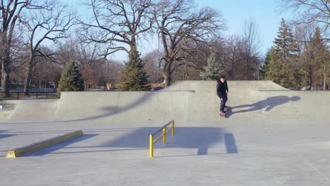 man-at-the-skatepark-does-a-grind-and-then-flips-the-skateboard-and-lands-it