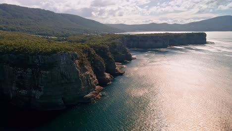 Backward-aerial-view-of-Tasman-National-Park-during-daytime-in-Australia