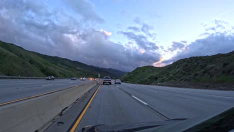 Sunset-drive-on-CA's-Hwy-14-near-Rosamond-with-traffic-and-cloudy-skies,-wide-angle,-timelapse