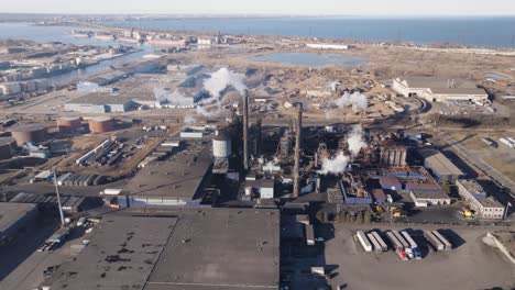 Industrial-zone-in-hamilton,-ontario-with-factories-and-smokestacks,-aerial-view