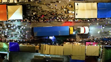 Drone-bird's-eye-view-above-tented-canopies-for-people-to-watch-carnaval-performers-in-Gran-Marcha