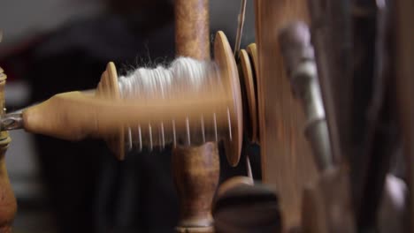 Traditional-Nordic-spinning-wheel-rolling-wool-yarn-onto-bobbin