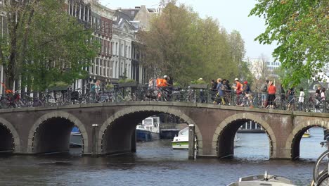 Pedestrians-and-bikers-passing-a-bridge-in-Amsterdam