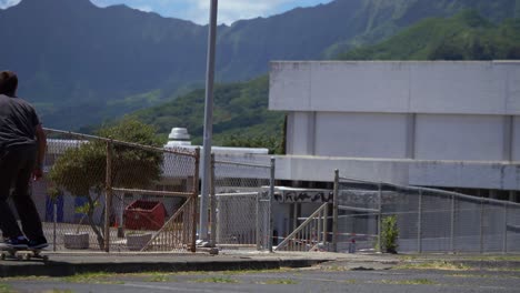 person-skateboarding-on-the-side-walk-in-hawaii-with-big-mountains