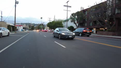 Sedan-driving-down-road---Roller-Shot