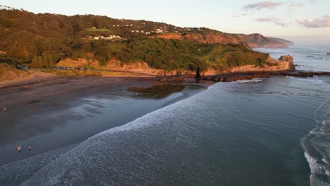 People-At-Sandy-Beach-Of-Muriwai-At-Sunrise-On-Maukatia-Bay-Shore-In-New-Zealand