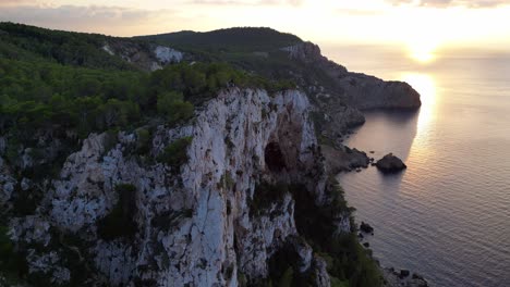 Sonnenuntergang-Auf-Ibiza-Mit-Blick-Auf-Eine-Felsige-Klippe-Und-Das-Ruhige-Meer