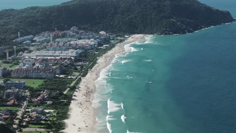 Crystal-clear-azure-waters-grace-the-shores-of-Praia-Brava,-nestled-in-the-northern-part-of-Florianopolis-Island,-Santa-Catarina,-Brazil