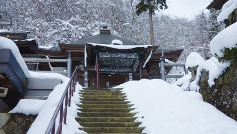 Snow-falling-over-Buddhist-Temple-in-Yamadera,-Japan