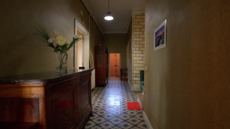 Slow-dolly-shot-revealing-a-long-hallway-within-a-antique-villa-in-Pignan