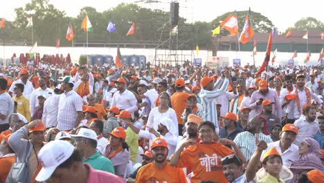 Indian-Prime-Minister-Narendra-Modi-supporters-with-BJP-political-flags-and-symbols-at-Race-Course-during-Lok-Sabha-election-campaign