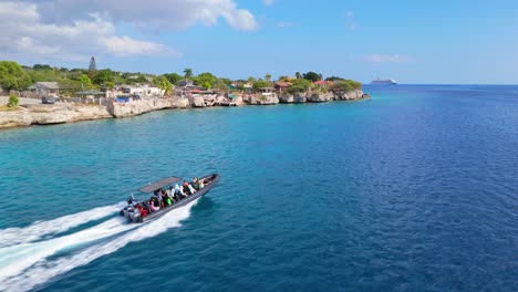 Aerial-rearview-tracking-follows-dive-tour-boat-in-Curacao