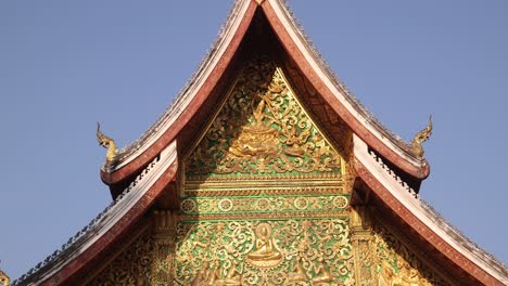 green-and-gold-exterior-of-buddhist-temple-in-Luang-Prabang,-Laos-traveling-Southeast-Asia