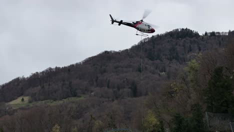 A-close-up-view-captures-a-rescue-helicopter-in-action-amidst-the-Swiss-Alps-in-Wessen